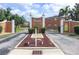 Welcoming entrance to Maria Manor with a brick sign and well-maintained landscaping at 4158 Tamiami Trl # G1, Port Charlotte, FL 33952