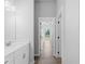 Bright bathroom leading to bedroom featuring a white vanity with modern hardware and tile floors at 4425 Lagoon Ter, North Port, FL 34286