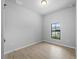Bright bedroom with window and wood look tile flooring at 4425 Lagoon Ter, North Port, FL 34286