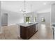 An airy open floor plan, featuring a kitchen island with modern sink and stylish pendant lighting at 4425 Lagoon Ter, North Port, FL 34286