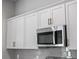 Modern kitchen with stainless steel microwave and white cabinets at 4425 Lagoon Ter, North Port, FL 34286