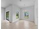 Bright living room with tile floors, modern lighting, and large windows showing a view of the outdoors at 4425 Lagoon Ter, North Port, FL 34286