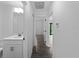 Hallway with updated flooring leading to a bathroom and main living area at 4453 Lagoon Ter, North Port, FL 34286