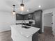 Beautiful kitchen featuring gray cabinets, stainless steel appliances, quartz countertop and an island with a sink at 4453 Lagoon Ter, North Port, FL 34286