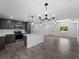 Bright open concept kitchen showcases gray cabinets, stainless appliances, and a kitchen island overlooking the living area at 4453 Lagoon Ter, North Port, FL 34286