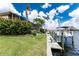 Lush backyard leading to a private boat dock, perfect for waterfront living and enjoying outdoor activities at 48 Colony Point Dr, Punta Gorda, FL 33950
