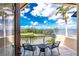 Enjoy views of the water from this tiled balcony with wrought iron railings and a cozy seating area at 48 Colony Point Dr, Punta Gorda, FL 33950