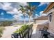 Enjoy the view of the ocean from this large balcony with a black wrought iron railing and seating for two at 48 Colony Point Dr, Punta Gorda, FL 33950