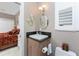 Cozy half bath featuring white fixtures, light-colored walls, and a charming mermaid-themed décor at 48 Colony Point Dr, Punta Gorda, FL 33950