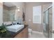 Updated bathroom featuring sleek fixtures, a large mirror, granite countertop, and a glass-enclosed shower at 48 Colony Point Dr, Punta Gorda, FL 33950