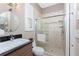 Neutral bathroom featuring a glass shower with neutral tile, modern fixtures, and a dark granite countertop at 48 Colony Point Dr, Punta Gorda, FL 33950