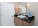 Bathroom featuring a white square basin sink with granite countertops and light-colored cabinetry at 48 Colony Point Dr, Punta Gorda, FL 33950