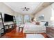 Spacious bedroom with wood floors, a ceiling fan, and French doors leading to a balcony at 48 Colony Point Dr, Punta Gorda, FL 33950