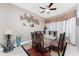 The spacious dining room features a glass table, modern lighting, and plantation shutters at 48 Colony Point Dr, Punta Gorda, FL 33950