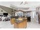 A well lit open concept kitchen with wood cabinets, granite countertops and an island with bar seating at 48 Colony Point Dr, Punta Gorda, FL 33950