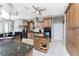 A functional kitchen with wood cabinets, an island with granite countertops and stainless steel appliances at 48 Colony Point Dr, Punta Gorda, FL 33950
