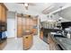 An open-concept kitchen with wood cabinets, granite countertops, wine cooler and tiled flooring at 48 Colony Point Dr, Punta Gorda, FL 33950