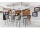 A spacious kitchen with an island that has bar stool seating, granite countertops and pendant lighting at 48 Colony Point Dr, Punta Gorda, FL 33950