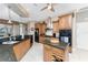 Kitchen featuring wood cabinets, granite countertops, stainless steel appliances and an island with breakfast bar at 48 Colony Point Dr, Punta Gorda, FL 33950