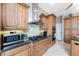 An updated kitchen with wood cabinets, stainless steel appliances and tile backsplash at 48 Colony Point Dr, Punta Gorda, FL 33950