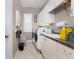 Well-equipped laundry room with appliances, ample storage cabinets, and a utility sink at 48 Colony Point Dr, Punta Gorda, FL 33950