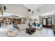 Open-concept living room with a high ceiling, tiled floors, and modern furniture at 48 Colony Point Dr, Punta Gorda, FL 33950