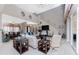 The expansive living area offers modern decor, views of the dining room, and a stairway at 48 Colony Point Dr, Punta Gorda, FL 33950