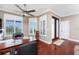 Bright office space with a ceiling fan, wood floors, a desk and multiple windows for natural light at 48 Colony Point Dr, Punta Gorda, FL 33950