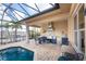 This home boasts a gorgeous outdoor kitchen featuring stainless steel appliances and a stunning pool view at 48 Colony Point Dr, Punta Gorda, FL 33950