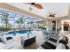 Spacious screened-in lanai with pool, dining, seating, and lush waterfront views at 48 Colony Point Dr, Punta Gorda, FL 33950