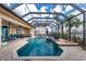 This large in-ground pool has a unique glass enclosure, fountains and is surrounded by a brick patio at 48 Colony Point Dr, Punta Gorda, FL 33950