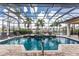 This luxurious pool area has a spa, beautiful fountains and is covered by a glass enclosure at 48 Colony Point Dr, Punta Gorda, FL 33950