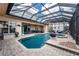 This luxurious pool boasts a glass enclosure, comfortable seating and is perfect for entertaining friends and Gathering at 48 Colony Point Dr, Punta Gorda, FL 33950