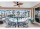 Inviting pool with dining, screened-in lanai, and tranquil waterfront views at 48 Colony Point Dr, Punta Gorda, FL 33950