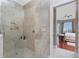 Walk-in shower adjacent to bedroom with neutral tile and built in shelf at 48 Colony Point Dr, Punta Gorda, FL 33950