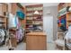 Spacious walk-in closet with extensive shelving and hanging racks for organized storage at 48 Colony Point Dr, Punta Gorda, FL 33950