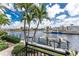 Picturesque waterfront view with boat dock, lush palm trees, and serene canals in a beautiful tropical setting at 48 Colony Point Dr, Punta Gorda, FL 33950