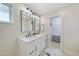 Bright bathroom featuring a double vanity and a walk-in closet at 530 Matares Dr, Punta Gorda, FL 33950
