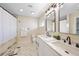 Spacious bathroom featuring a double vanity, large mirrors, and modern fixtures at 530 Matares Dr, Punta Gorda, FL 33950