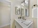 Bathroom featuring a white vanity, modern lighting, and updated fixtures at 530 Matares Dr, Punta Gorda, FL 33950