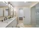 Bright bathroom featuring a double vanity and a walk-in closet at 530 Matares Dr, Punta Gorda, FL 33950