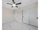 Bedroom with marble floors, a ceiling fan, and ample closet space at 530 Matares Dr, Punta Gorda, FL 33950