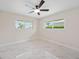 Bright bedroom with a ceiling fan and a view of the screened-in pool at 530 Matares Dr, Punta Gorda, FL 33950