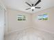 Bedroom featuring marble floors, a ceiling fan, and bright natural light at 530 Matares Dr, Punta Gorda, FL 33950