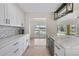 Beautiful kitchen with white cabinets, granite countertops, stainless appliances, and a wine fridge at 530 Matares Dr, Punta Gorda, FL 33950