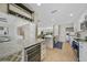 Modern kitchen featuring white cabinetry, granite countertops, stainless steel appliances, and wine storage at 530 Matares Dr, Punta Gorda, FL 33950