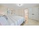 Bright main bedroom with a king bed, decorative mirrors, and marble floors throughout at 530 Matares Dr, Punta Gorda, FL 33950