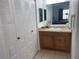 This bathroom features tile flooring, a vanity with storage, and a large mirror at 6728 Thorman Rd, Port Charlotte, FL 33981