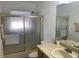 This bathroom features a shower with glass doors and a vanity with storage at 6728 Thorman Rd, Port Charlotte, FL 33981