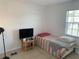 This bedroom has neutral colored walls with tile flooring and a window at 6728 Thorman Rd, Port Charlotte, FL 33981